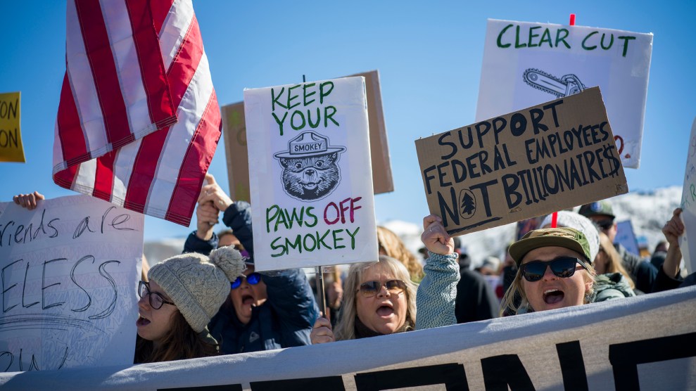 Protesters hold signs that say "keep your hands off smokey" and " support public workers not billionares"