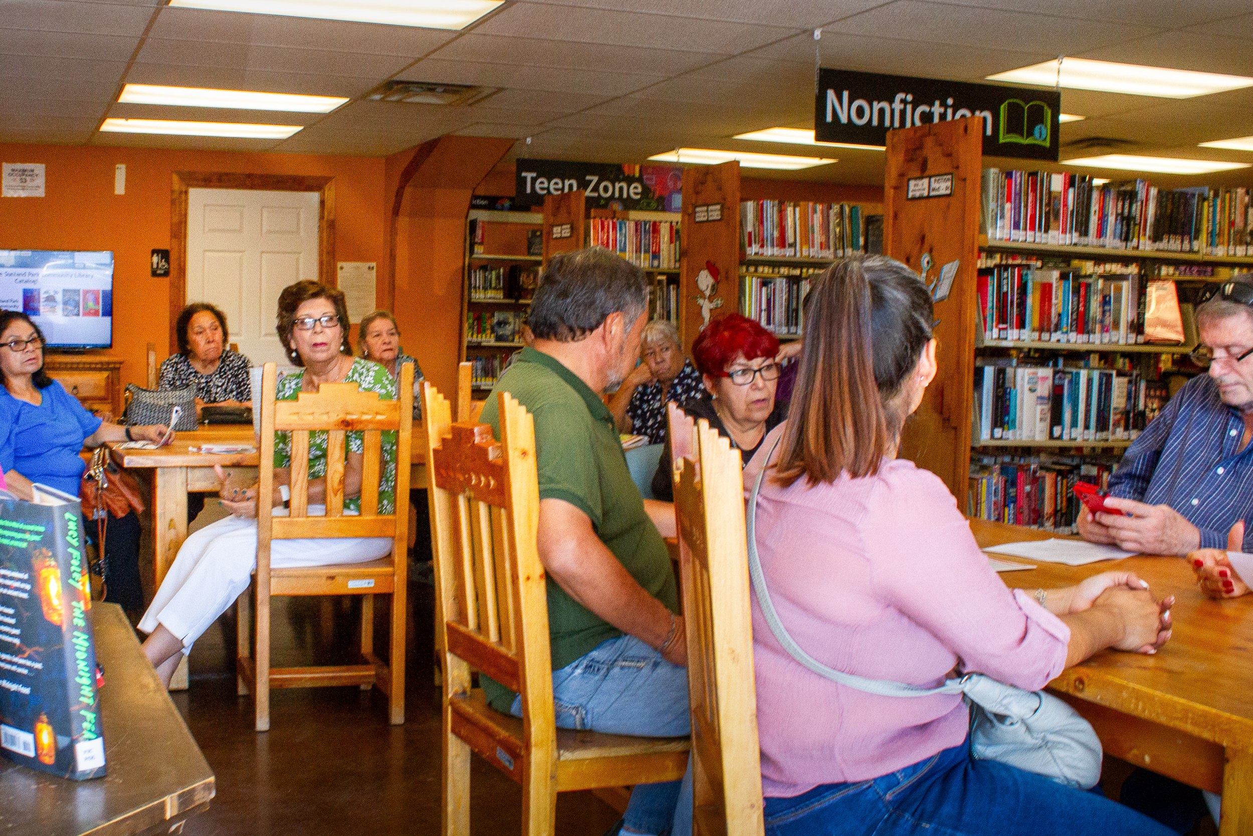 A group of people gathered in a library.