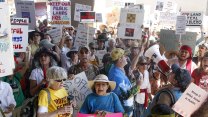 A crowd of protesters with signs opposing proposed sales of public land by the federal government.