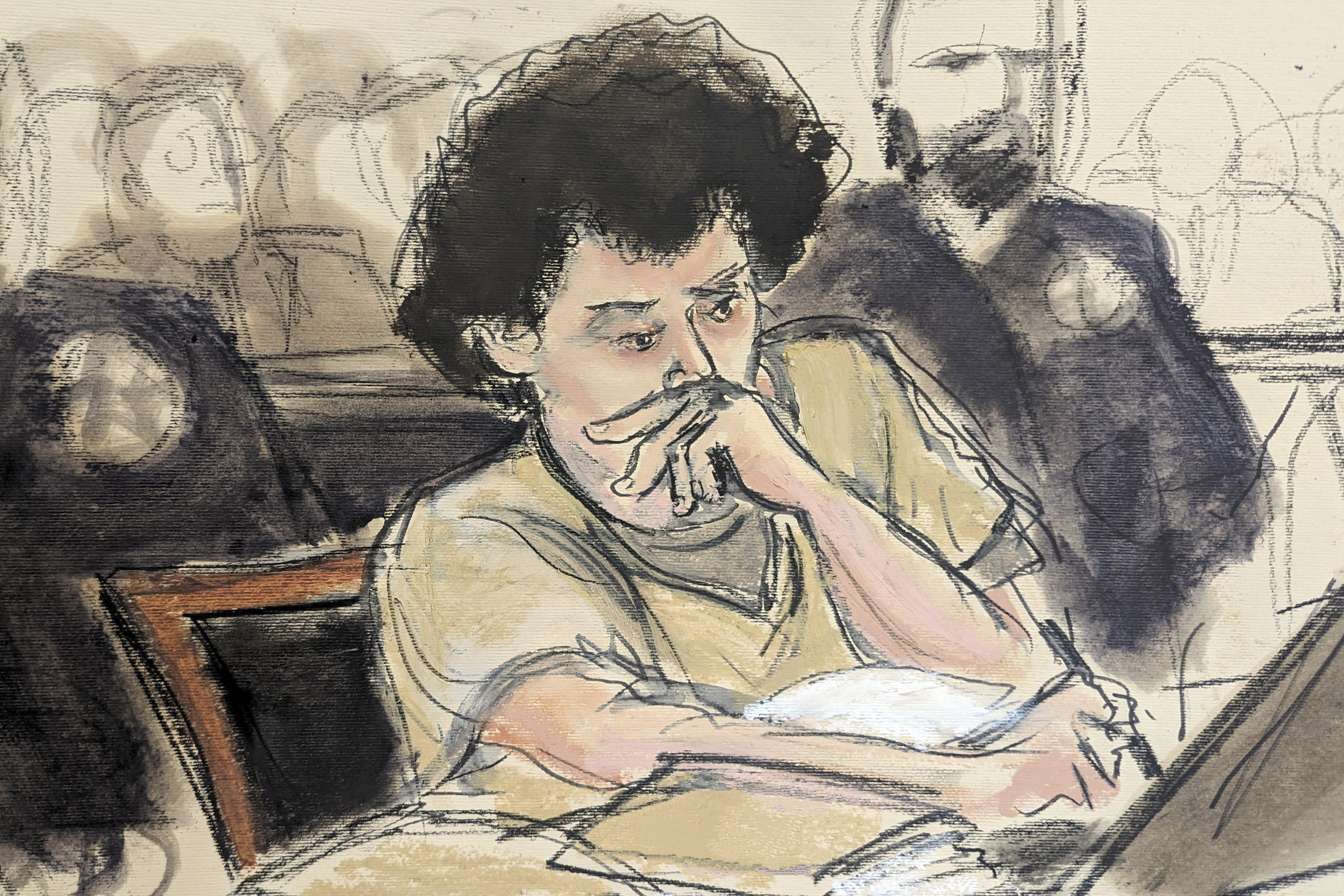 A sketch of a young man with curly hair in brown, shortsleeve garb. As he's sitting at a table, he's holding a pen to paper. Baliffs a and a crowd of people are loosely drawn behind him.