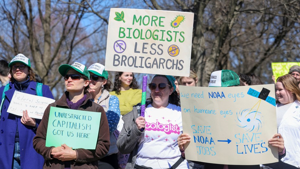 A person wearing a shirt that says ecologist holds a sign that says "More biologists, less broligarchs." Others surround them with similar science-themed signs.
