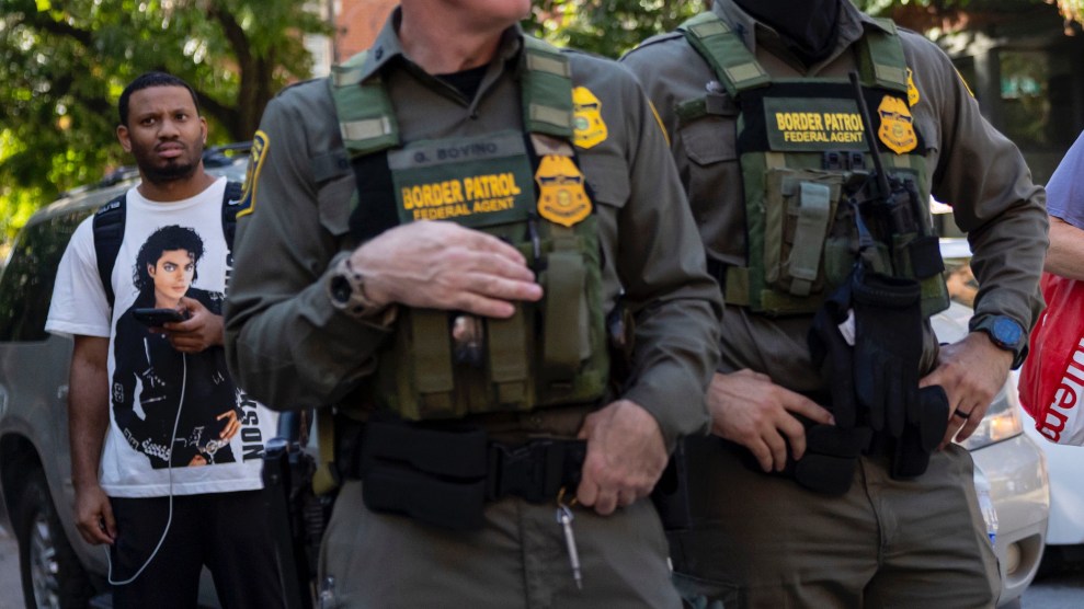 A Chicago man wearing a Michael Jackson shirt eyes Border Patrol officials.