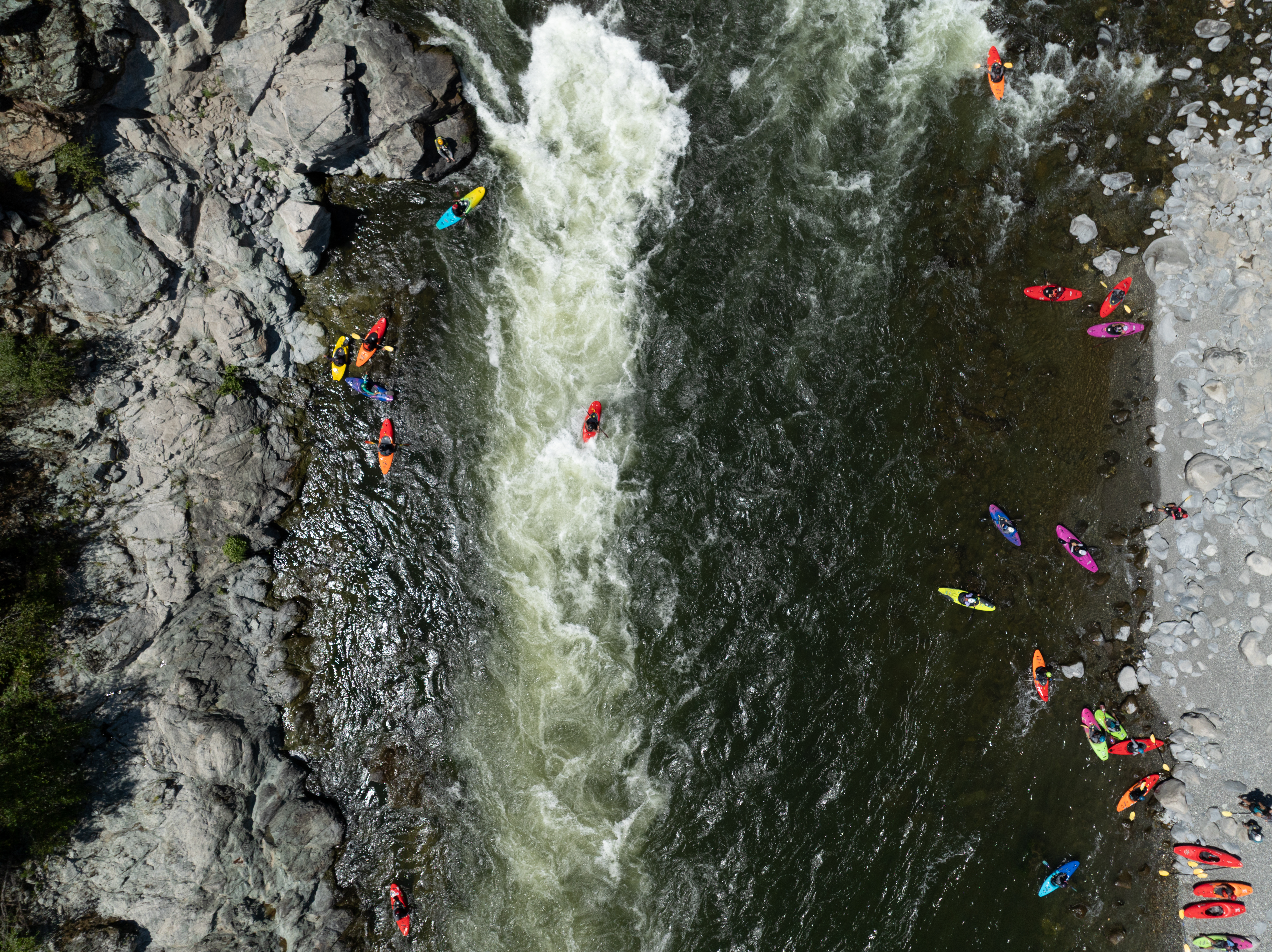 An aerial view of kayakers on a river.