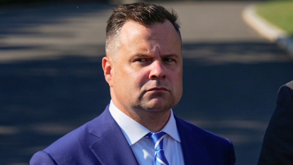 Bill Pulte wearing a blue suit and a stern, maybe concerned, look