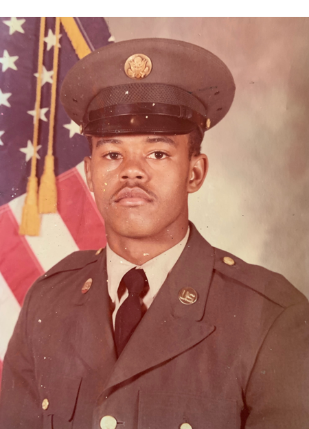 A portrait of a young African American man with a thin mustache in military dress uniform and hat.