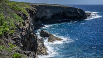 A steep cliff next to bright blue ocean