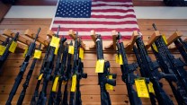 AR-15-style rifles displayed under an American flag at the Kittery Trading Post, Aug. 9, 2024, in Kittery, Maine (AP/Charles Krupa)