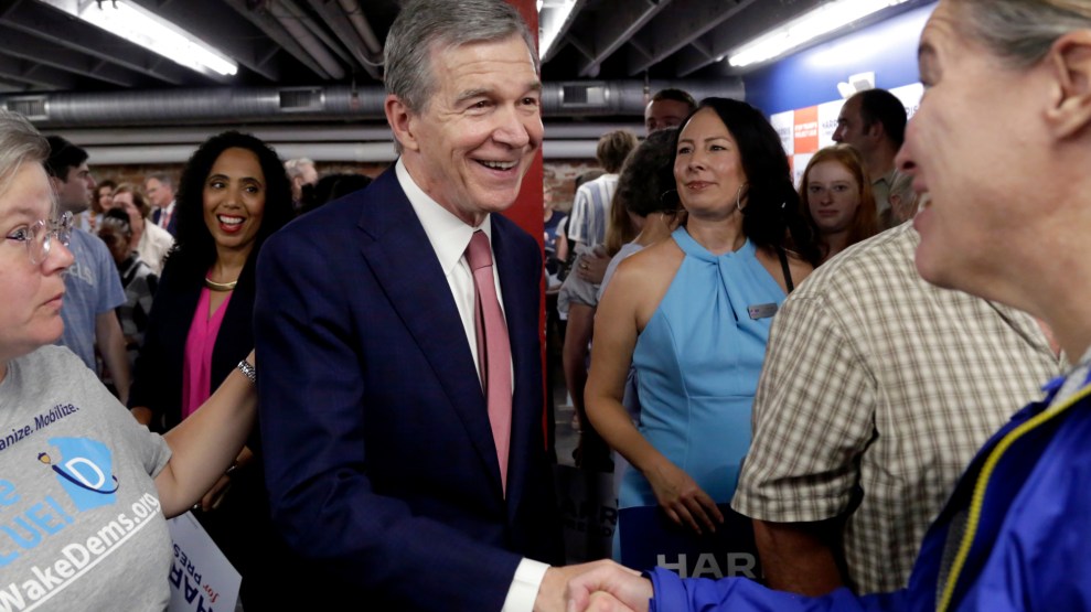 A man in a suit shaking a woman's hand
