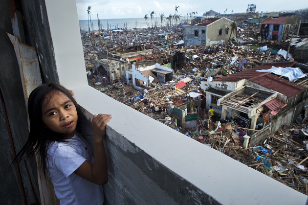 A young girl looks out over the devastated town of Tanauan in Leyte province, the Philippines.