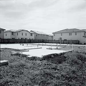 Empty houses and unfinished slabs fill a subdivision in Lathrop, California.